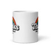 White ceramic mug with a rainbow and the text "Thanks for the childhood trauma' printed on both sides.