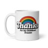 White ceramic mug with a rainbow and the text "Thanks for the childhood trauma' printed on both sides.