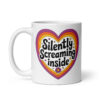 White ceramic coffee mug with a colorful graphic that says 'Silently screaming inside'. The graphics are printed on both sides of the mug.