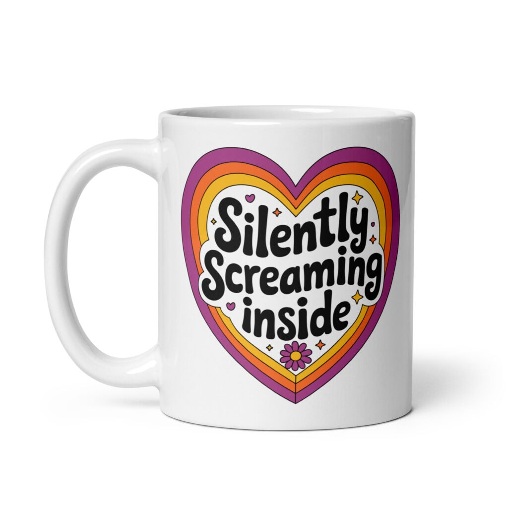 White ceramic coffee mug with a colorful graphic that says 'Silently screaming inside'. The graphics are printed on both sides of the mug.