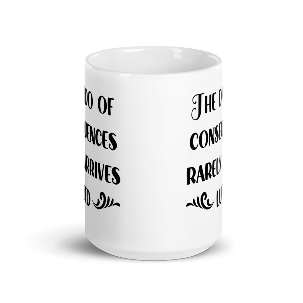 White ceramic mug with the text 'The dildo of consequences rarely arrives lubed' printed on both sides.