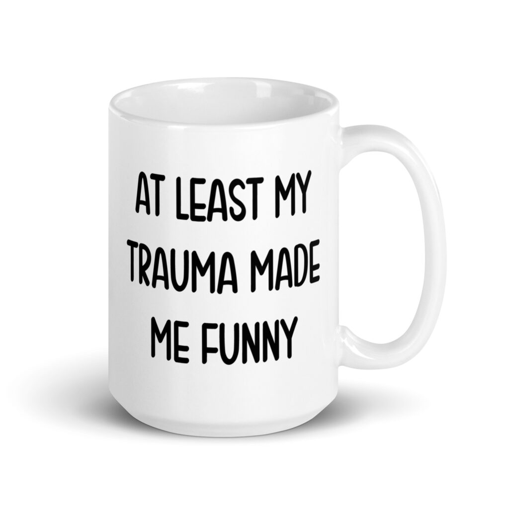 White ceramic mug with the text 'At least my trauma made me funny' printed on both sides.