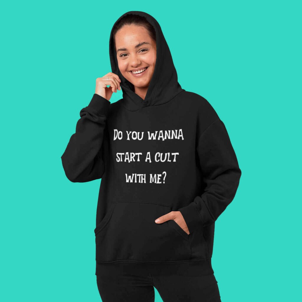 Woman wearing a black hoodie sweatshirt with the text 'Do you wanna start a cult with me' printed on the front.