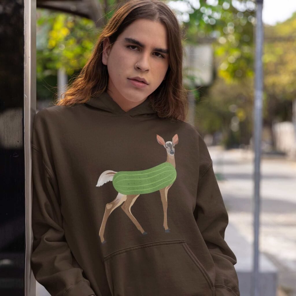 Man wearing dark chocolate brown dildo pun hoodie sweatshirt with funny image of a doe deer with a dill pickle body printed on the front.