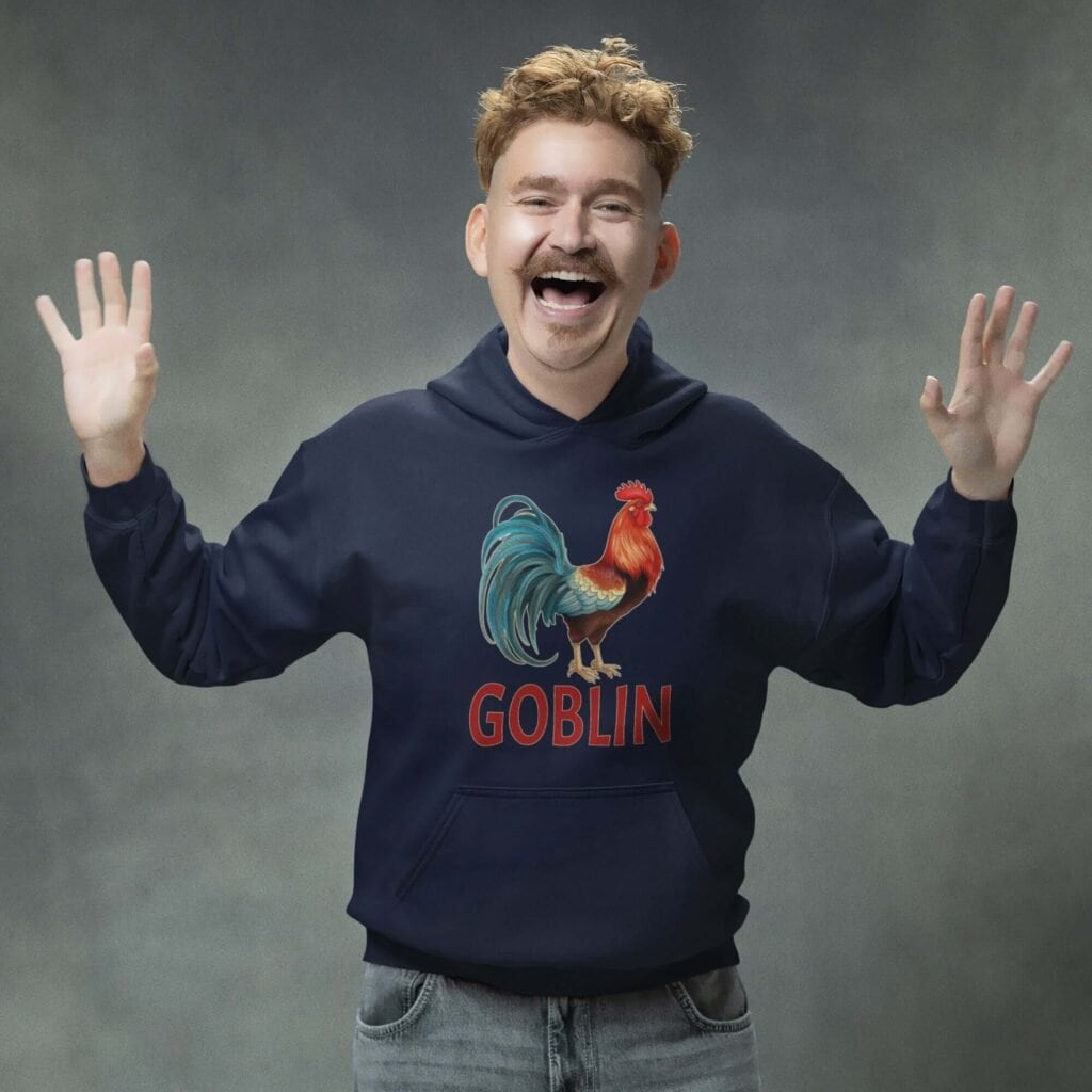 Funny man wearing a navy blue hoodie with an image of a rooster and the word 'Goblin' printed under the rooster. The graphics are printed on the front of the hoodie.