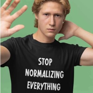 Man wearing a black t-shirt with the text 'Stop normalizing everything' printed on the front.