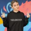 Woman wearing funny black hoodie sweatshirt with the word Psychology printed in reverse on the front.