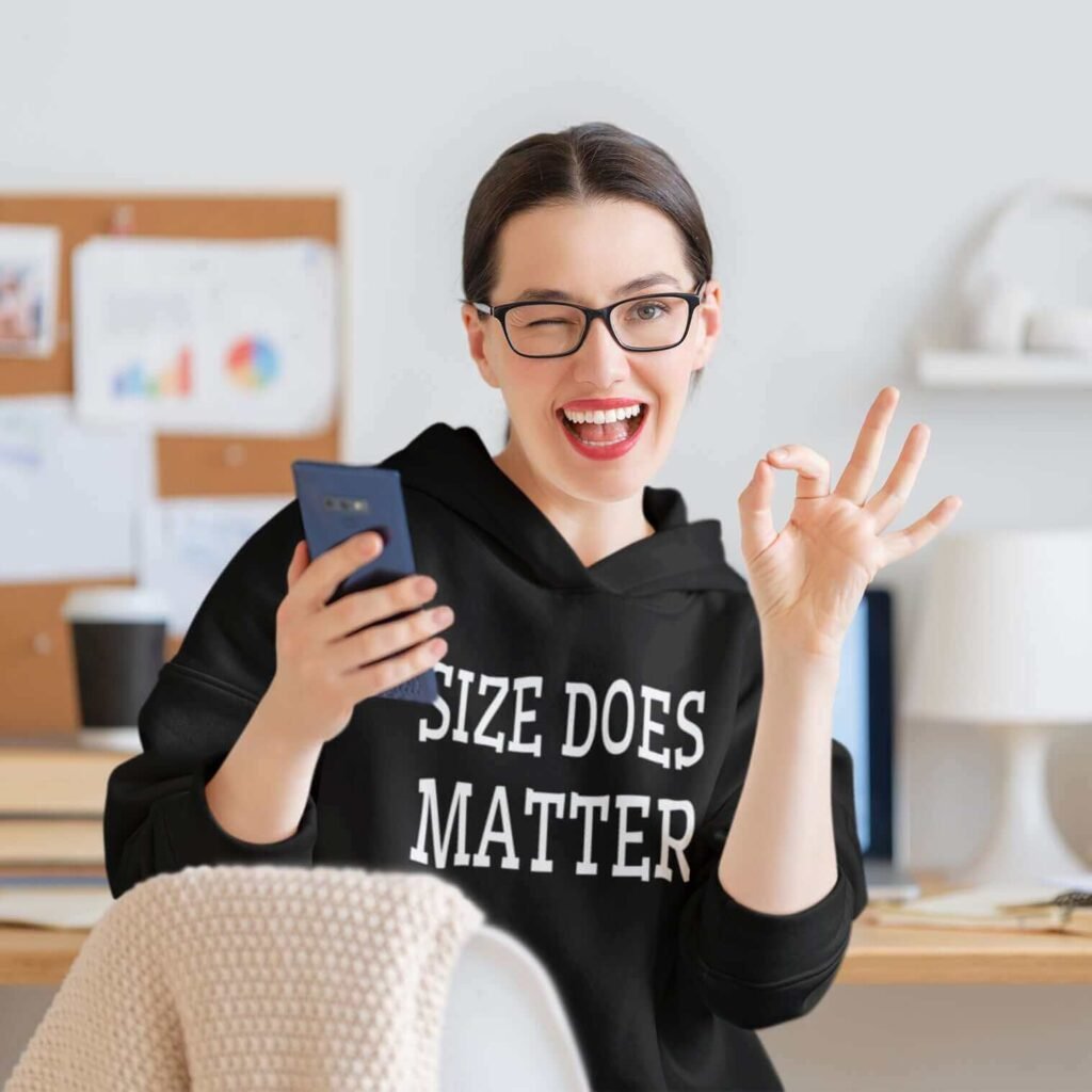 Winking woman wearing a black hoodie sweatshirt with the text 'Size does matter' printed on the front.
