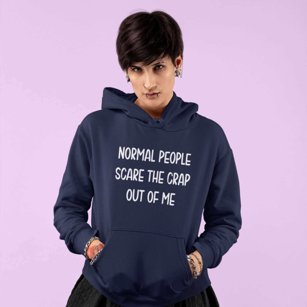 Woman wearing navy blue hoodie sweatshirt with the text 'Normal people scare the crap out of me' printed on the front.