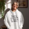 Woman wearing a white hoodie sweatshirt with the text 'Please be patient with me, I'm from the 1900's' printed on the front.