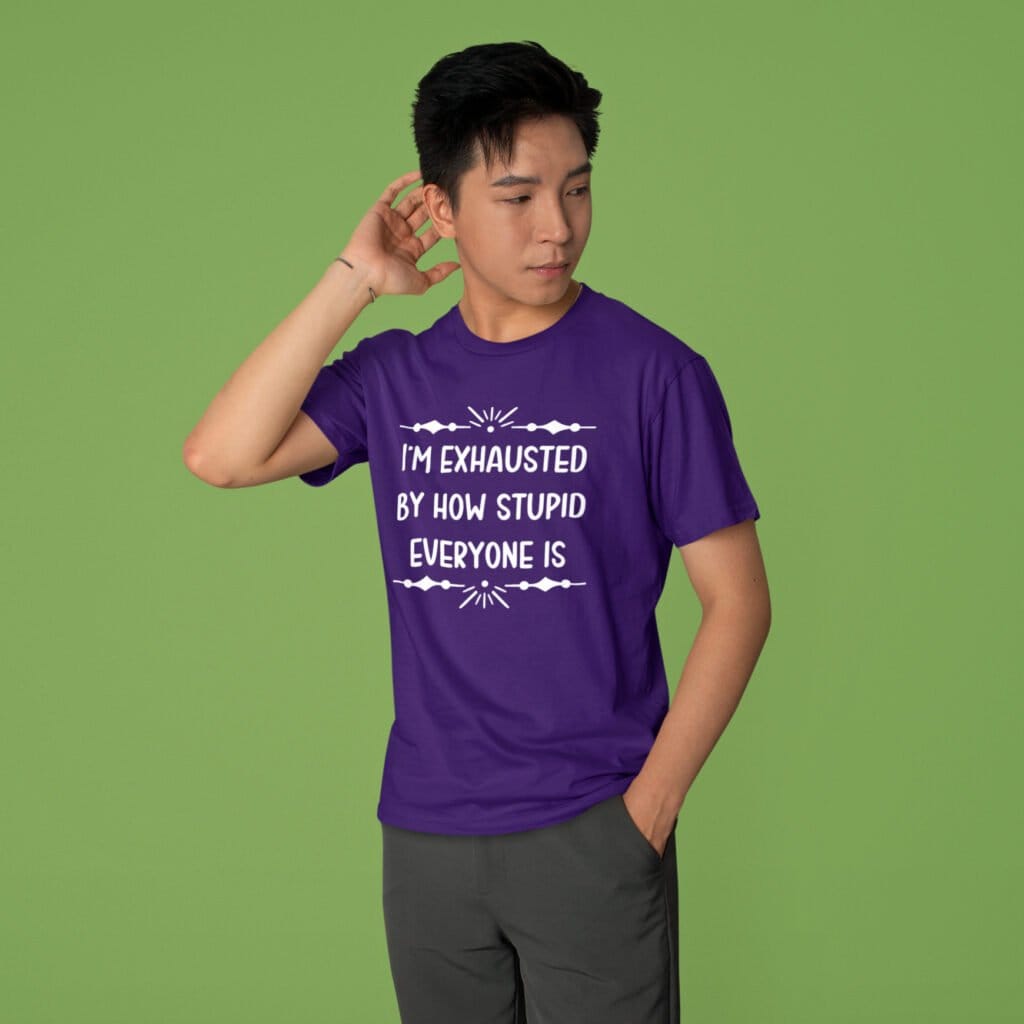 Man wearing a purple t-shirt with the text 'I'm exhausted by how stupid everyone is' printed on the front.