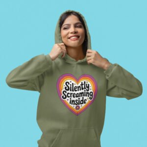 Woman wearing a military green hoodie sweatshirt with a colorful graphic that says 'Silently screaming inside'. The graphics are printed on the front.