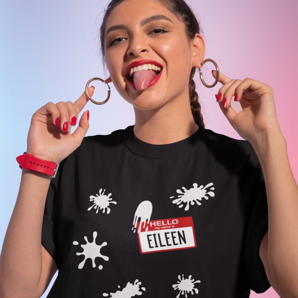 Woman wearing black t-shirt with Eileen name tag and white splatters printed on the front.