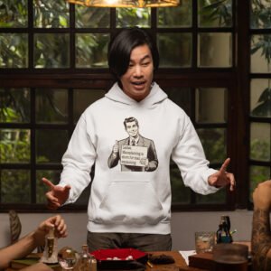 Man wearing a white hoodie sweatshirt with graphic of a retro man holding sign that says 'Ladies, mansplaining is short for man explaining' printed on the front.