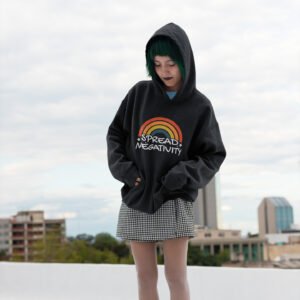 Woman wearing a black hoodie sweatshirt with a graphic of a rainbow and the words 'Spread negativity' printed on the front.