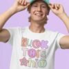 Man wearing hat and white t-shirt with colorful pastel font 'Fuck this shit' graphics printed on the front.