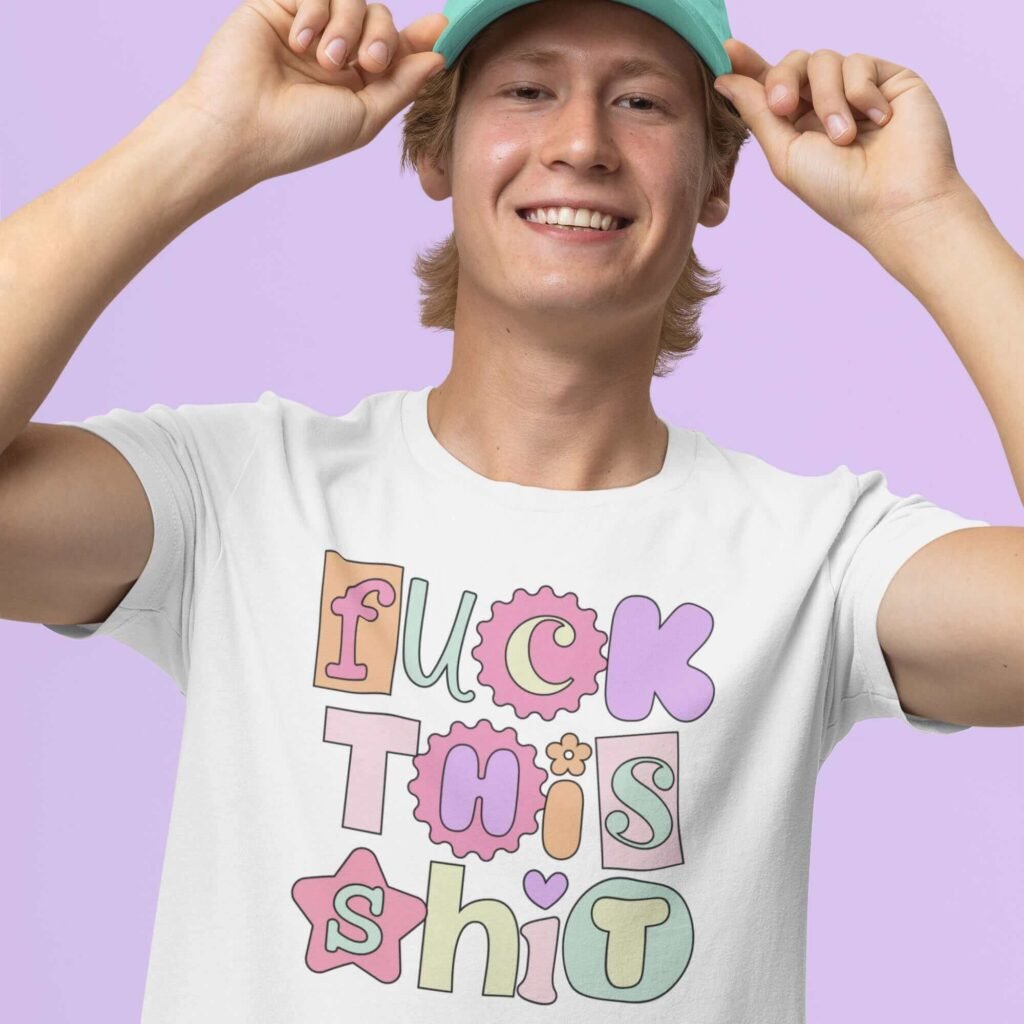 Man wearing hat and white t-shirt with colorful pastel font 'Fuck this shit' graphics printed on the front.