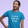 Man wearing a Sapphire blue t-shirt with the text 'At least my trauma made me funny' printed on the front.