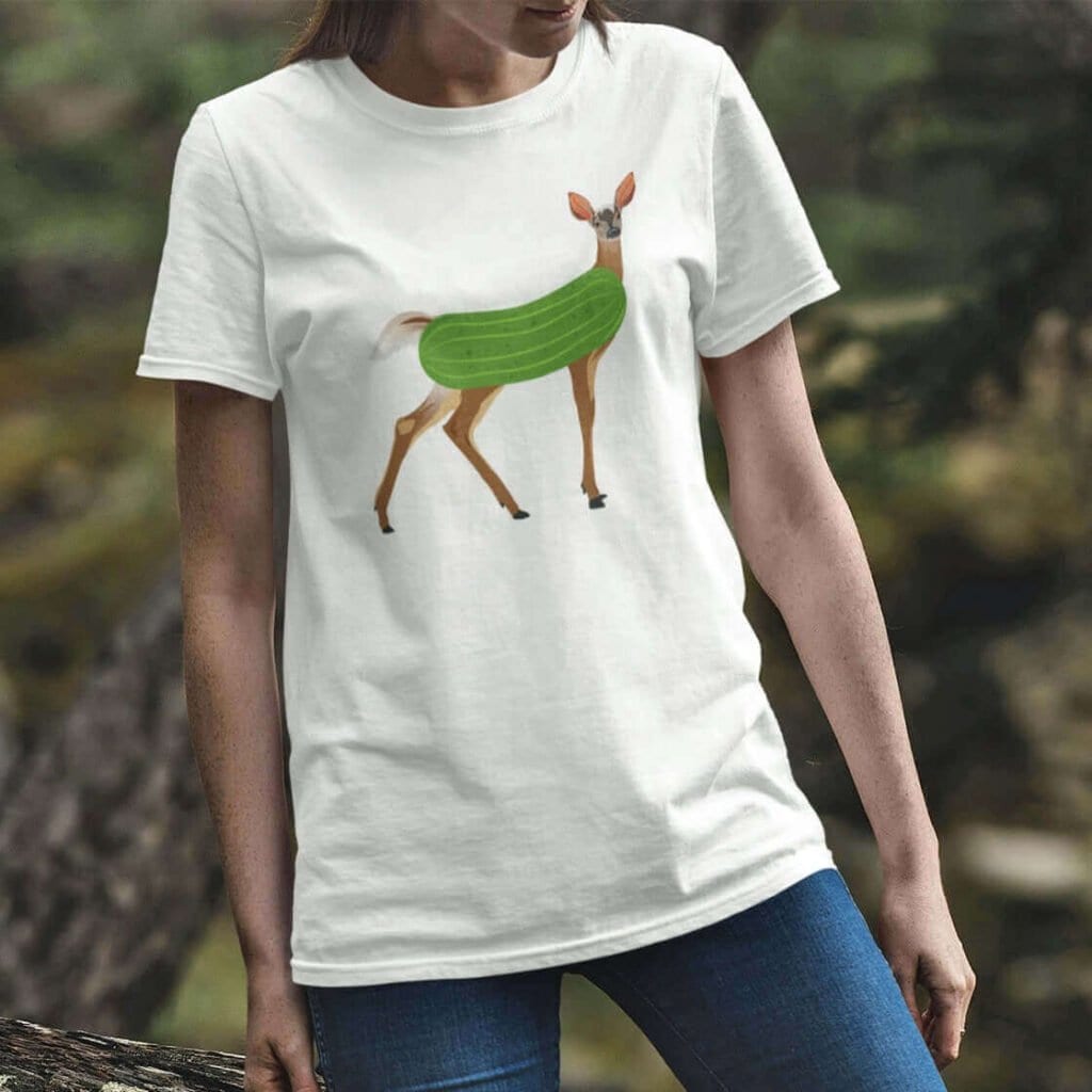 Woman wearing white dildo pun t-shirt with funny image of a doe deer with a dill pickle body printed on the front.