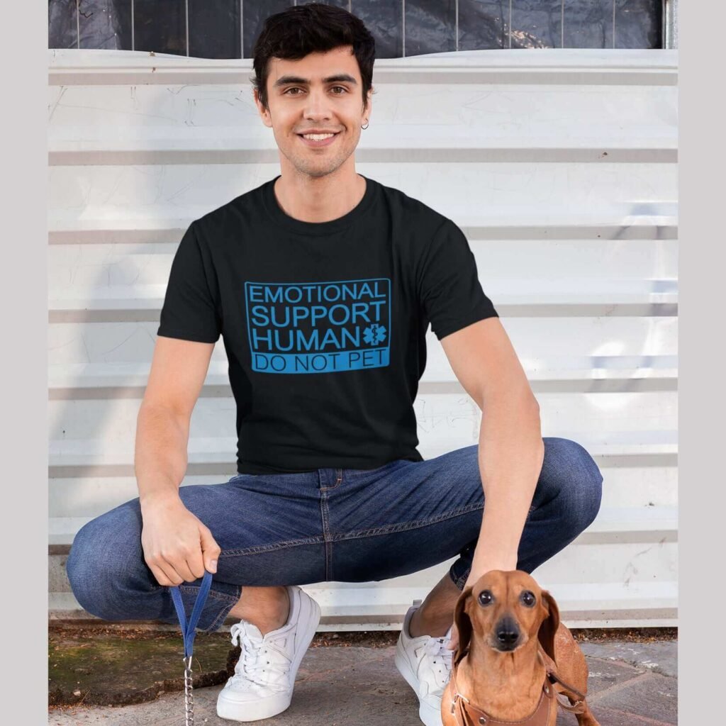 Man wearing a black t-shirt with the text 'Emotional support human. Do not pet' printed on the front.