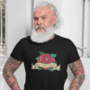 Tattooed bearded man wearing a black t-shirt with a funny image of an old school rose flash tattoo & the words 'No ragrets'. The word regrets is intentionally misspelled.
