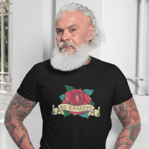 Tattooed bearded man wearing a black t-shirt with a funny image of an old school rose flash tattoo & the words 'No ragrets'. The word regrets is intentionally misspelled.