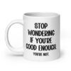White ceramic mug with the phrase 'Stop wondering if you're good enough. You're not.' printed on both sides of the mug. The words 'You're not' are smaller then the rest.