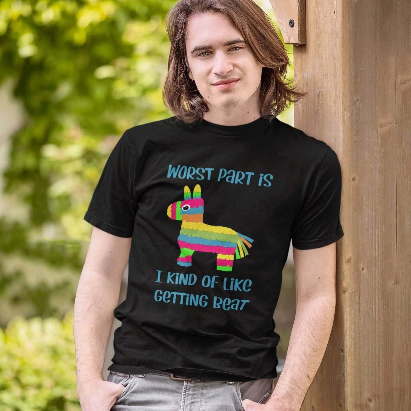 Man wearing a black t-shirt with an image of a colorful donkey pinata with the words 'Worst part is I kind of like getting beat' printed on the front.