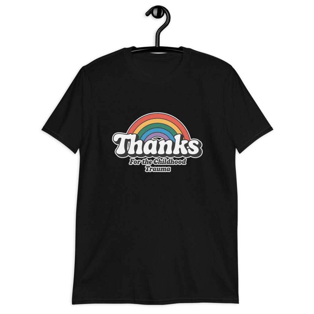 Black t-shirt with an image of a rainbow and the words 'Thanks for the childhood trauma' printed on the front. The word Thanks is large and the rest of the words are smaller under.