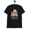 Black t-shirt with an image of grey haired older woman enjoying a bite of a piece of cake with the words 'I hope your cake is as moist as I am' printed on the front.