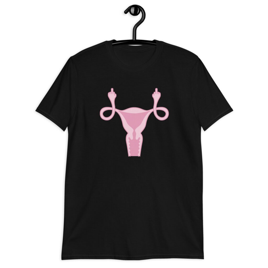 Black t-shirt with image of a pink uterus flipping middle finger graphic printed on the front.