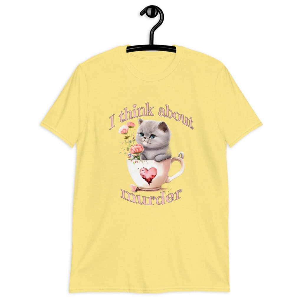 Cornsilk yellow t-shirt that says 'I think about murder' with image of cute fluffy kitten sitting in a teacup printed on the front.