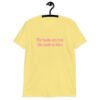 Cornsilk yellow t-shirt with the text 'The boobs are real, the smile is fake.' printed in pink on the front.