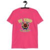 Heliconia pink t-shirt with an image of a flower and the words Be kind above the flower in yellow bold block font. The words Of a bitch are smaller in script font under the flower. The design is printed on the front of the shirt.