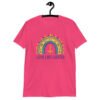 Heliconia pink t-shirt with an image of a boho style rainbow. There is an upside down cross in the center arch of the rainbow and the text 'Love like Lucifer' printed under. The graphics are printed on the front.