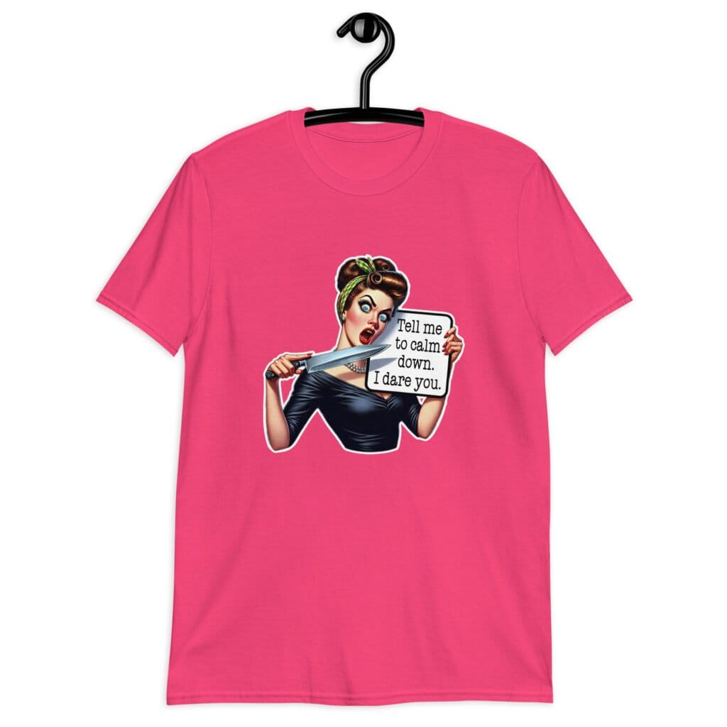 Heliconia pink t-shirt that has a graphic of an angry looking retro woman holding a knife and a sign. The sign says 'Tell me to calm down. I dare you.' The graphic is printed on the front of the shirt.