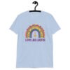 Light blue t-shirt with an image of a boho style rainbow. There is an upside down cross in the center arch of the rainbow and the text 'Love like Lucifer' printed under. The graphics are printed on the front.