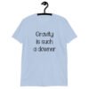 Light blue t-shirt with the text 'Gravity is such a downer' printed on the front.