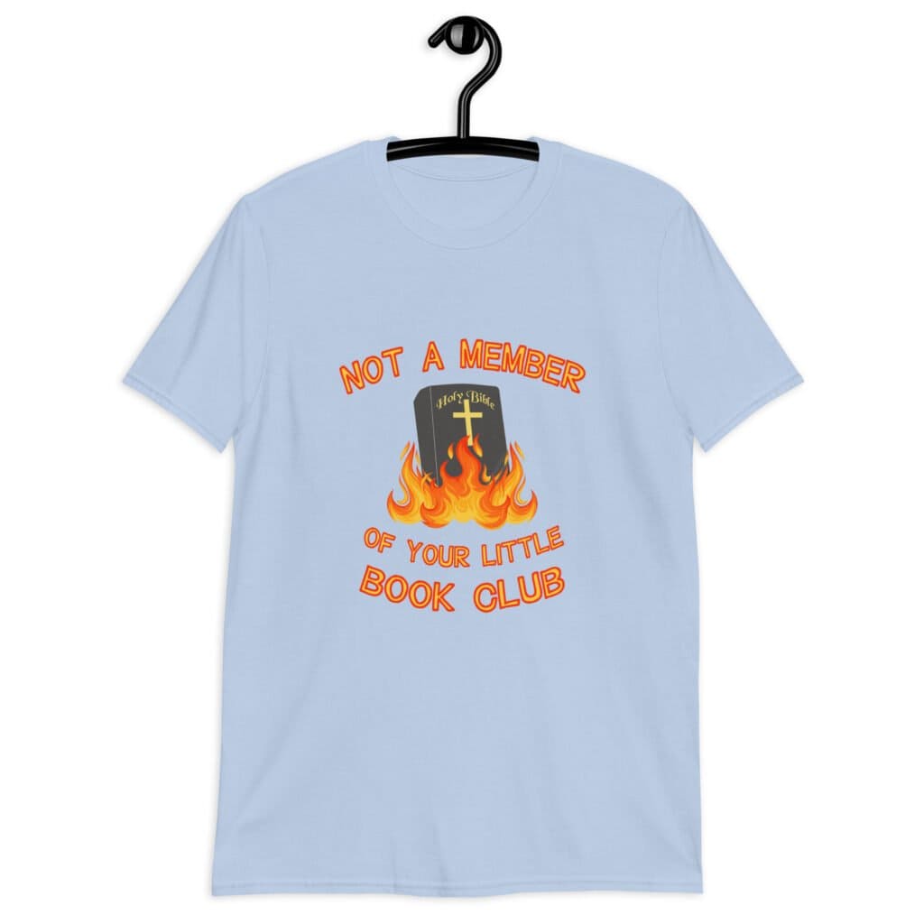 Light blue t-shirt with image of a burning bible and the text 'Not a member of your little book club' printed on the front.