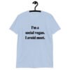 Light blue t-shirt with the pun phrase 'I'm a social vegan. I avoid meet.' printed on the front.