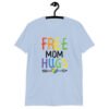 Light blue t-shirt with the text 'Free Mom hugs' in rainbow lettering printed on the front.
