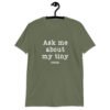 Military green t-shirt with the text 'Ask me about my tiny penis' printed on the front. The word tiny is much smaller than the rest of the text.