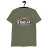Military green t-shirt with an image of a rainbow and the words 'Thanks for the childhood trauma' printed on the front. The word Thanks is large and the rest of the words are smaller under.