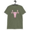 Military green t-shirt with image of a pink uterus flipping middle finger graphic printed on the front.