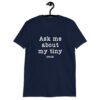 Navy bleu t-shirt with the text 'Ask me about my tiny penis' printed on the front. The word tiny is much smaller than the rest of the text.