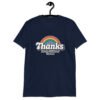 Navy blue t-shirt with an image of a rainbow and the words 'Thanks for the childhood trauma' printed on the front. The word Thanks is large and the rest of the words are smaller under.