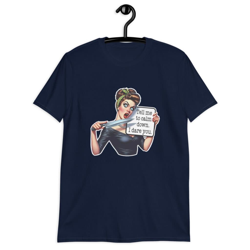 Navy blue t-shirt that has a graphic of an angry looking retro woman holding a knife and a sign. The sign says 'Tell me to calm down. I dare you.' The graphic is printed on the front of the shirt.