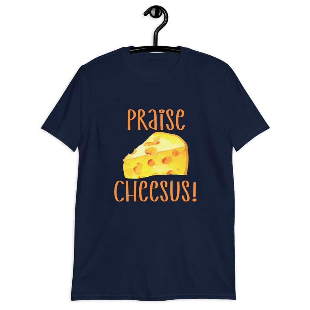 Navy blue cheese pun t-shirt with funny graphics of a piece of swiss cheese and the text 'Praise Cheesus' printed on the front of the shirt in yellow and orange.