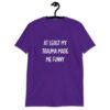 Purple t-shirt with the text 'At least my trauma made me funny' printed on the front.