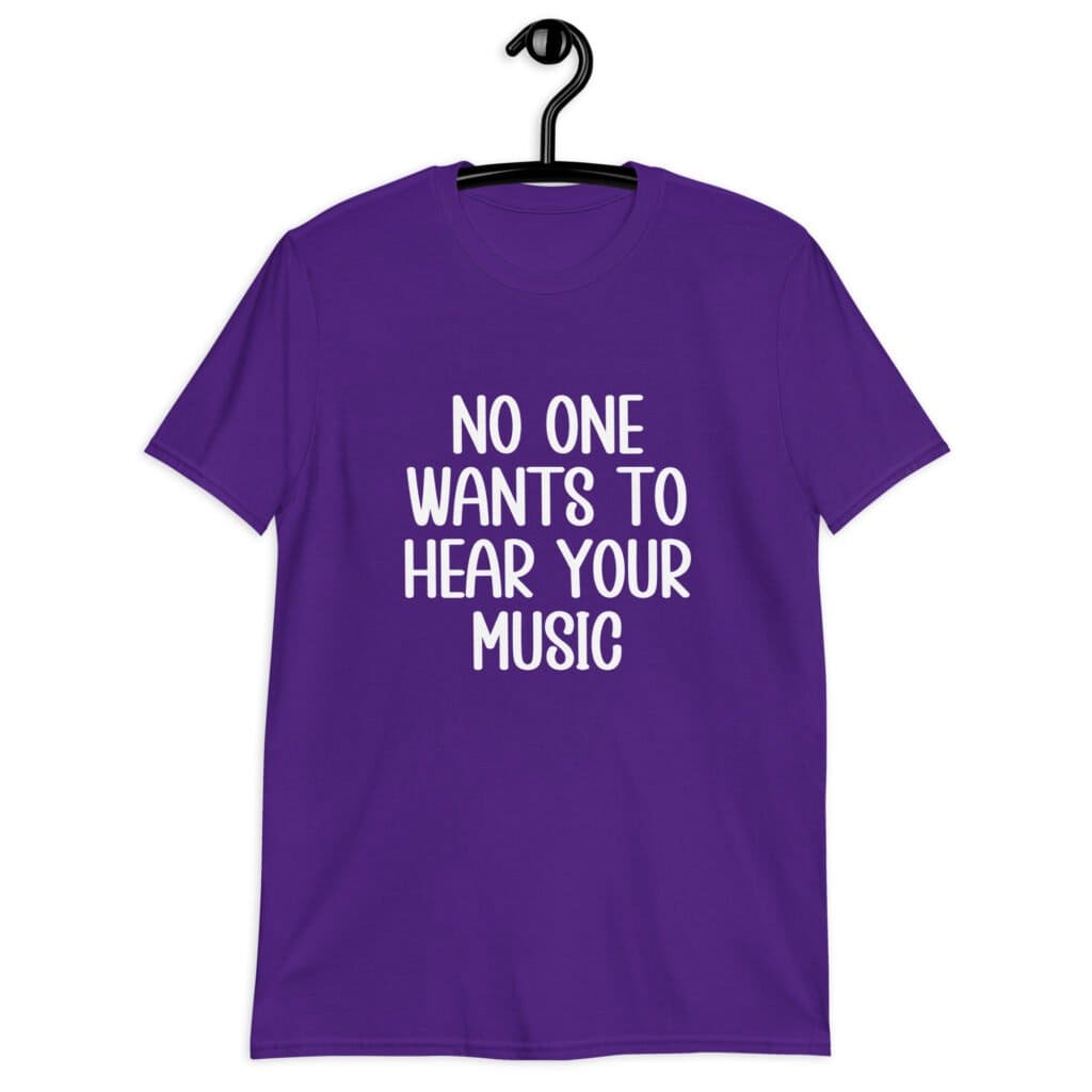 Purple t-shirt with the text 'No one wants to hear your music' printed on the front.